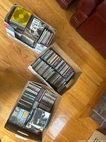 Three boxes full of music CDs visible with original cases and inserts.
