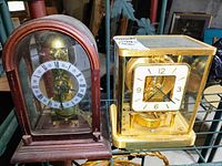 Front view of both clocks on metal shelving