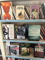Books arranged on shelves showing titles and binding types for identification.