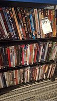 Two shelves of assorted DVDs showing titles including Moulin Rouge, Lord Jim, and others.