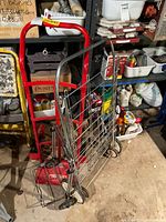 Side view of red Craftsman hand truck showing one tire and taped base platform.