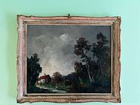 Full view of the larger framed painting showing a rural house scene with a red roof under cloudy sky and surrounding trees.