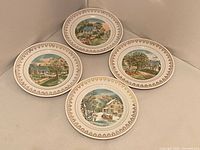 All four Currier & Ives seasonal plates displayed together