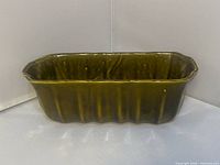 Full side view of green glazed rectangular planter