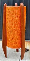 Full front view showing teak tripod frame and orange woven fabric shade
