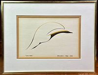 Full view of framed art print titled 'Sun Bird' depicting a minimalist bird form in black and gold on textured paper with cream and gold mat and gold frame.