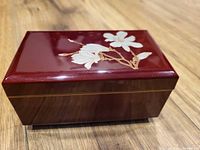 Closed Otagiri burgundy lacquer music jewelry box with magnolia motif