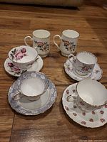 Group shot of four teacup & saucer pairs and two mugs