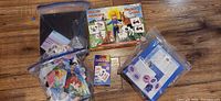Overall view showing bags of Hatchimals and Frozen game pieces, Memory Game box, puzzle pieces and flash cards deck
