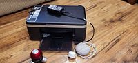 Overall lot showing HP printer, AC adapter on top, Google Nest Mini with power cable, HoMedics massager