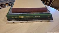 Stack of five horse riding and driving books showing spines