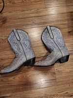 Side view of both boots displaying leather, stitching and heel