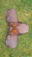 Top view of brown leather saddle on grass