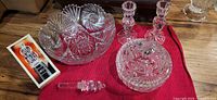 All five crystal pieces grouped on red cloth