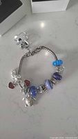 Bracelet with attached charms on countertop