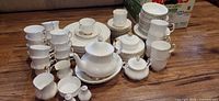 Entire dinnerware set arranged on floor showing quantity and pattern