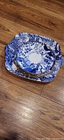 front view of stacked blue-white square and round plates