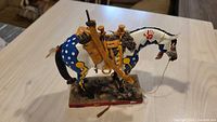 Left side view of painted pony figurine on base
