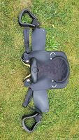 Top view of entire saddle with stirrups attached on grass