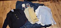 Group shot of jackets, breeches and shirts on floor