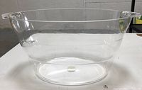 Front angle view of the clear acrylic beverage tub showing its shape and clarity