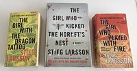 Front covers of three Stieg Larsson books: The Girl With The Dragon Tattoo, The Girl Who Played With Fire, The Girl Who Kicked The Hornet's Nest.