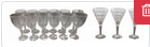 Photo of 12 clear plastic wine glasses with stems and rounded bowls, alongside 3 clear plastic martini glasses.