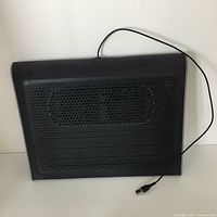 Front view of black Targus Lap Chill Mat showing perforated metal mesh surface and attached USB cable.