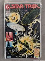 Star Trek comic book issue #49 with cover showing an explosion in space featuring spaceships and the Star Trek logo.