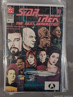 Cover of Star Trek The Next Generation Comic Issue #20, featuring several crew members and the Starship Enterprise, showing wear on the cover.