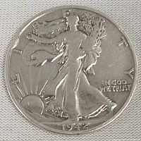 Obverse side of the 1942 Walking Liberty half dollar coin showing Liberty walking with the date 1942 and 'IN GOD WE TRUST'.