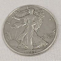 Obverse side of the 1943 USA Walking Liberty Half Dollar coin showing Lady Liberty walking with sun rising in background, year 1943 visible.