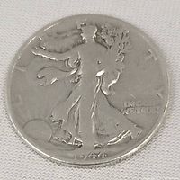 Front side of the 1944 half dollar coin showing the Walking Liberty figure and the year 1944.
