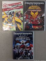 Front view of three Transformers DVDs: Robots in Disguise Mission Discovery, Prime Beast Hunters Predacons Rising, and Prime Beast Hunters Season Three.