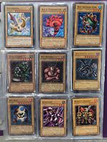 Photo showing 9 Yu-Gi-Oh! cards in protective sleeves including Red-Eyes B. Dragon and Robotic Knight.