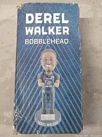 Front of box showing Derel Walker bobblehead illustration and name