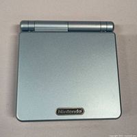 Top view closed showing silver Nintendo Game Boy Advance SP with Nintendo logo.