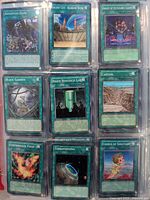 Photo showing nine Magic the Gathering spell cards including Advanced Dark, Ancient City Rainbow Ruins, Array of Revealing Light, Black Garden, Brain Research Lab, Canyon, Centrifugal Field, Terraforming, Chorus of Sanctuary.