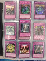 Photo of binder page showing 9 Yu-Gi-Oh! trap cards, including Absolute End, Acid Trap Hole, Adhesion Trap Hole, Alien Brain, Altar for Tribute, Alchemist Emulate, Altergeist Haunted Rock, Amazoness Archers.