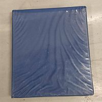 Blue binder with a textured cover containing the trading cards.