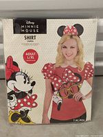 Front packaging photo of Disney Minnie Mouse Adult L/XL shirt showing shirt design and model image on front