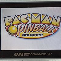 Close-up photo of the Game Boy Advance SP screen showing the Pacman Pinball Advance title screen.