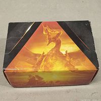 Closed cardboard box with Magic: The Gathering dragon artwork on front.
