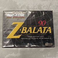 Front of sealed box showing Top Flight Z 90 Balata branding and 12 golf balls indication.