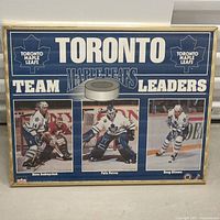 Front view of the Toronto Maple Leafs framed poster showing three players and maple leaf logos.