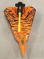 Top view of the Transformers G2 Cyber Jets Hooligan toy in jet mode showing orange and black tiger stripes and yellow weapon mounted on top.