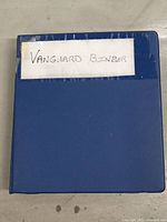 Blue binder labeled 'Vanguard Binder' from front.