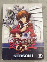 Photo of front cover of Yu-Gi-Oh! GX Season 1 DVD box set featuring character and mech dragon artwork.