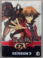 Front cover of the YU-GI-OH! GX Season 3 DVD box set, showing anime characters and series title with DVD count.