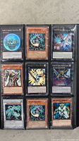 Page showing 9 Yu-Gi-Oh! cards including Chaos Sorcerer, Photon Thrasher, Skull Commander, and Magician of Faith.